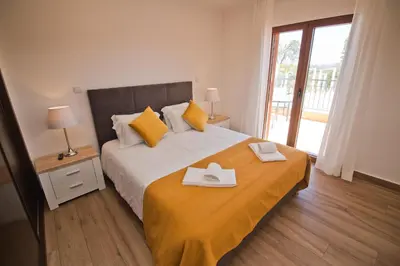 a bedroom with a bed with two towels on it at Casa da Ladeira Branca in Lagos