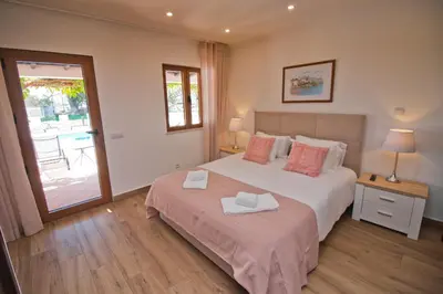 a bedroom with a bed with two towels on it at Casa da Ladeira Branca in Lagos