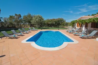 a swimming pool with lounge chairs and a poolvisor at Casa da Ladeira Branca in Lagos