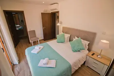 a bedroom with a bed with two towels on it at Casa da Ladeira Branca in Lagos