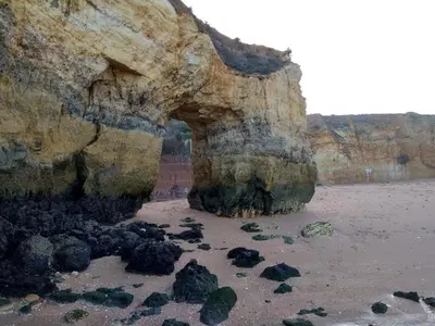 a large rock formation on a sandy beach at Magnoliamar 409 in Lagos