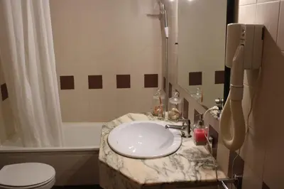 a bathroom with a sink and a shower and a toilet at Magnoliamar 409 in Lagos