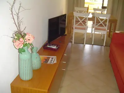 a living room with two vases with flowers on a table at Magnoliamar 409 in Lagos