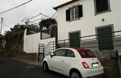a small white car parked in front of a house at Paradise View in Gaula