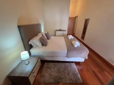 a room with two sliding doors and a bedroom at Penthouse Quinta Village Garajau in Caniço