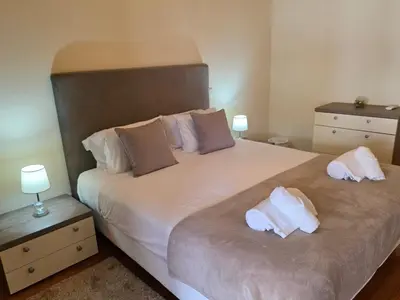 a bedroom with a bed and a sliding glass door at Penthouse Quinta Village Garajau in Caniço