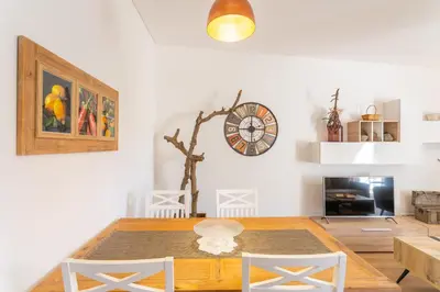 a dining room with a table and a clock on the wall at FLH Quintinha Rocha in Funchal
