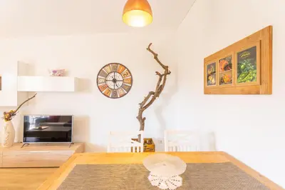 a dining room with a table and a clock on the wall at FLH Quintinha Rocha in Funchal