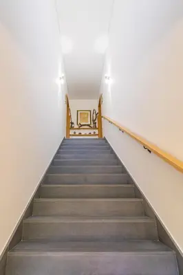 a staircase in a building with grey carpeted stairs at FLH Quintinha Rocha in Funchal