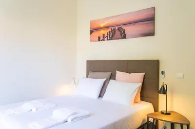 a bedroom with a bed with white pillows at FLH Quintinha Rocha in Funchal