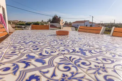 a table with a blue and white pattern on it at Residencia Quinta do Poço Guesthouse in Sagres