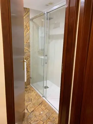 a shower with a glass door in a bathroom at Ilha Atlântico in Caniço