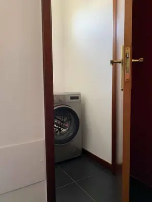 a washer and dryer in a laundry room at Ilha Atlântico in Caniço