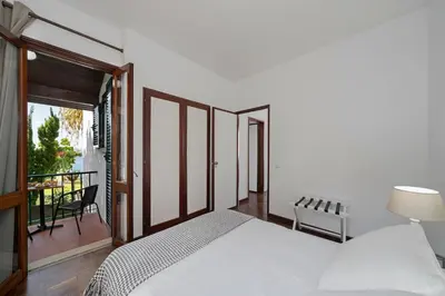 a bedroom with a white bed and a balcony at Casa do Lido by An Island Apart in Funchal
