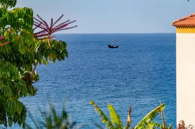 a boat in the middle of the ocean at Casa do Lido by An Island Apart in Funchal