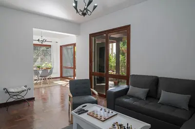 a living room with a couch and a table at Casa do Lido by An Island Apart in Funchal