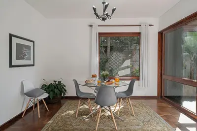 a dining room with a table and chairs and a window at Casa do Lido by An Island Apart in Funchal