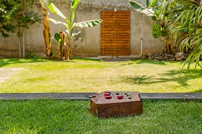 a set of four red shoes sitting on the grass at Casa do Lido by An Island Apart in Funchal