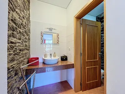 a bathroom with a sink and a mirror at Quinta do Serrado II in Ribeira da Janela