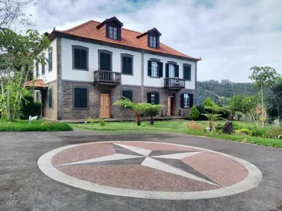 a house with a star in front of it at Quinta do Serrado II in Ribeira da Janela