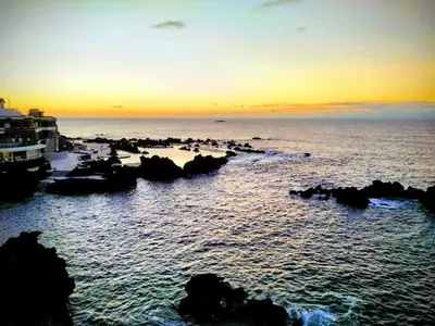 a group of people on the beach at sunset at Quinta do Serrado II in Ribeira da Janela