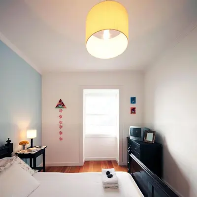 a bedroom with a bed and a yellow ceiling at Casa do João da Eira in Seixal