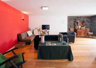 a living room with a couch and a table at Casa do João da Eira in Seixal
