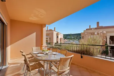 a patio with a table and chairs on a balcony at Luxury Holiday 2-bedroom Apartment Praia da Luz in Luz