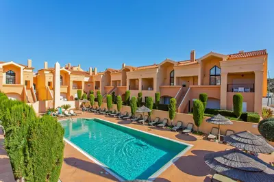 a villa with a swimming pool and a resort at Luxury Holiday 2-bedroom Apartment Praia da Luz in Luz