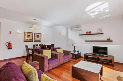 a living room with a couch and a table at Luxury Holiday 2-bedroom Apartment Praia da Luz in Luz