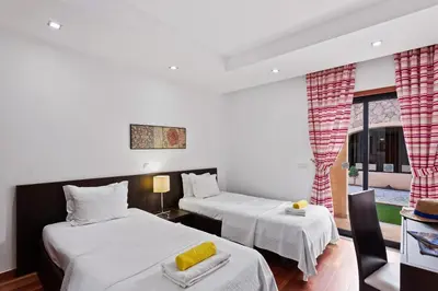 a room with two beds and a window at Luxury Holiday 2-bedroom Apartment Praia da Luz in Luz