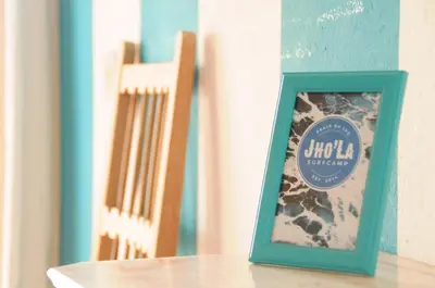 a picture frame sitting on top of a table at Jho'La Surf Camp in Luz