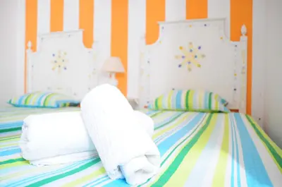 a bedroom with two beds with towels on them at Jho'La Surf Camp in Luz