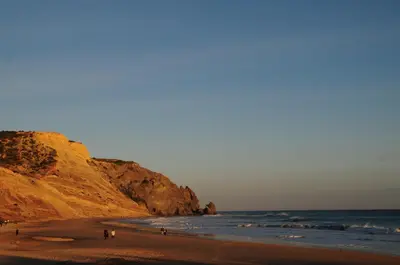 a group of people walking on a beach near the ocean at Jho'La Surf Camp in Luz