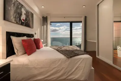 a bedroom with a large bed with a large window at VILLA PARADISE - Modern and Sophisticated in Funchal