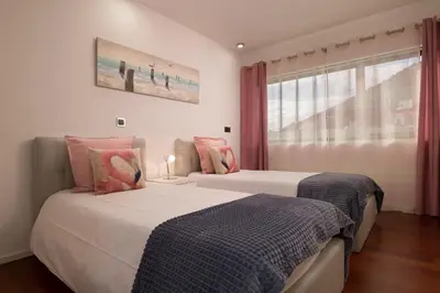 two beds sitting next to each other in a bedroom at VILLA PARADISE - Modern and Sophisticated in Funchal