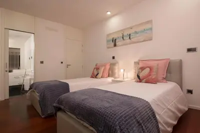 a bedroom with two beds and a bathroom at VILLA PARADISE - Modern and Sophisticated in Funchal