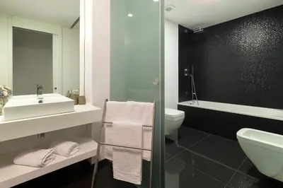 a bathroom with a sink and a toilet and a shower at VILLA PARADISE - Modern and Sophisticated in Funchal