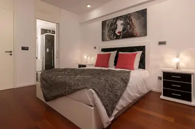 a bedroom with a large bed with red pillows at VILLA PARADISE - Modern and Sophisticated in Funchal