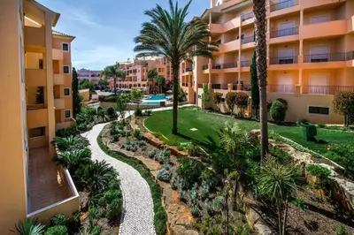 an aerial view of a resort with a pathway and palm trees at Apartamento Boa Estrela in Luz
