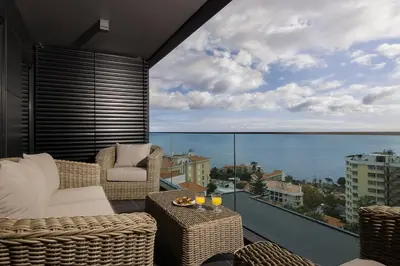 a balcony with chairs and a view of the ocean at Angel´s Paradise Luxury and Sophistication in Funchal