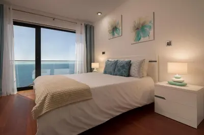 a bedroom with a large bed and a large window at Angel´s Paradise Luxury and Sophistication in Funchal