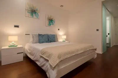 a bedroom with a large bed with two lamps on it at Angel´s Paradise Luxury and Sophistication in Funchal