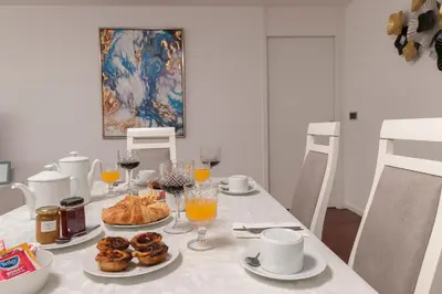 a table with plates of pastries and glasses of orange juice at Angel´s Paradise Luxury and Sophistication in Funchal