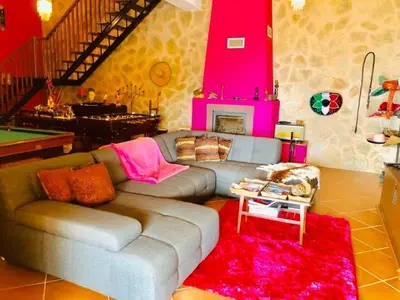a living room with a couch and a table at Villa Safari Charm in Ribeira Brava