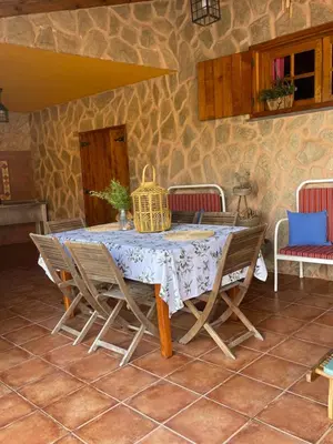 a dining room table with chairs and a bird cage on it at Villa Safari Charm in Ribeira Brava
