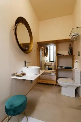 a bathroom with a sink and a mirror and a toilet at Dazk Golden Estate in Ribeira Brava