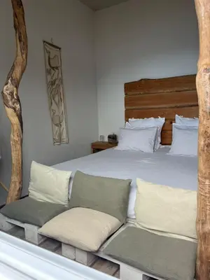 a bedroom with a large bed with pillows at Janela para o Atlântico in Porto Moniz