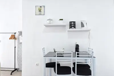 a table and chairs in a room with white walls at Vista Mar, a Home in Madeira in Ponta do Sol