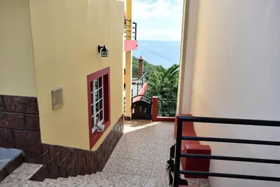 a room with a window on the side of a building at Vista Mar, a Home in Madeira in Ponta do Sol
